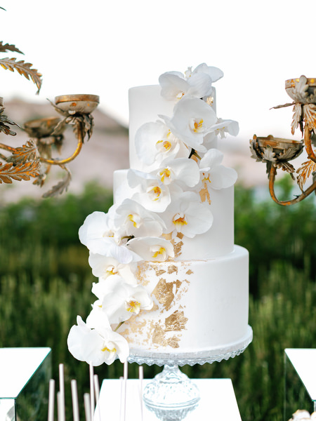 Three-tier white wedding cake with orchid details at Island Resort The Residence luxury Nigerian wedding reception in Athens.