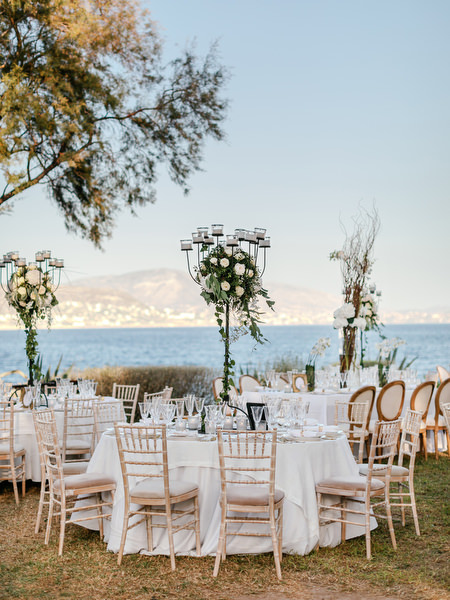 Reception detail with gold candelabras and sea view at Island Resort The Residence Athens luxury Nigerian wedding.