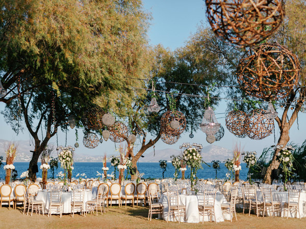 Woven hanging décor and floral centerpieces at Island Resort The Residence luxury wedding reception Athens Riviera.