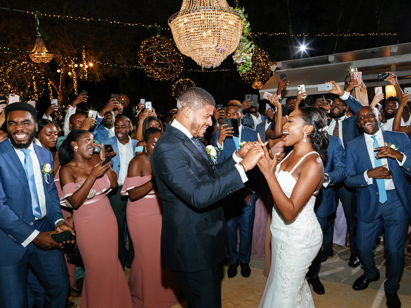 Bride and groom dancing surrounded by guests at Island Resort The Residence Nigerian wedding reception in Athens Riviera.