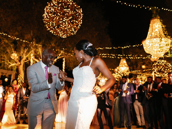 Bride dancing under decorative chandeliers at Island Resort The Residence Nigerian wedding in Athens Riviera.