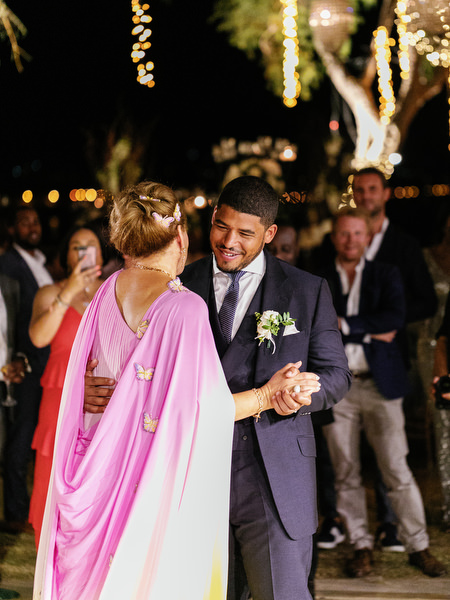 Groom dancing with mother during luxury Nigerian wedding reception at Island Resort The Residence Athens Riviera.