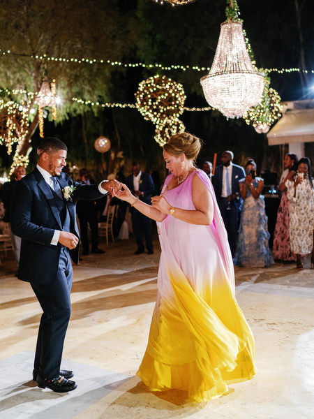 Groom dancing with mother during luxury Nigerian wedding reception at Island Resort The Residence Athens Riviera.