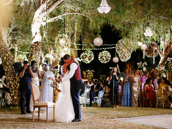 Guests clapping and celebrating during reception at Island Resort The Residence luxury Nigerian destination wedding in Athens.