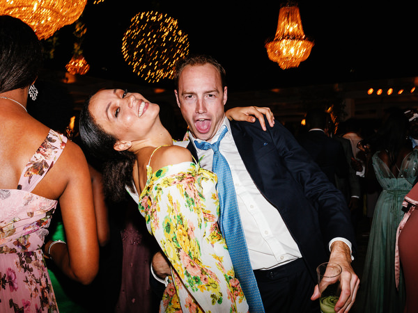 Friends dancing on packed dance floor at Island Resort The Residence luxury wedding reception in Athens Riviera.