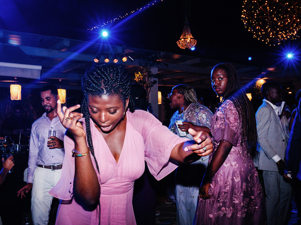 Crowded dance floor celebration at Island Resort The Residence during 400-guest Nigerian wedding in Athens.