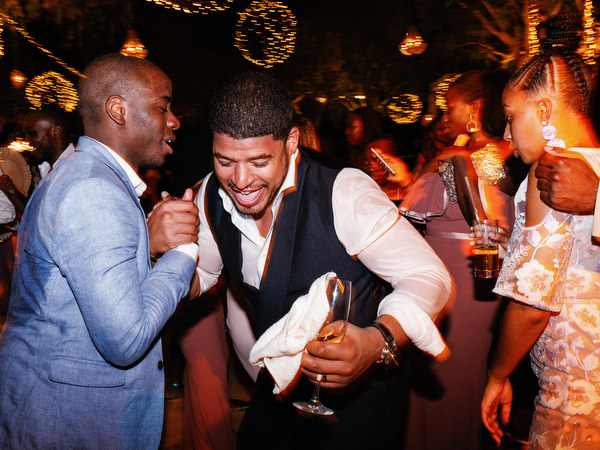 Friends dancing on packed dance floor at Island Resort The Residence luxury wedding reception in Athens Riviera.