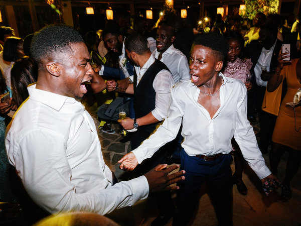 Crowded dance floor celebration at Island Resort The Residence during 400-guest Nigerian wedding in Athens.