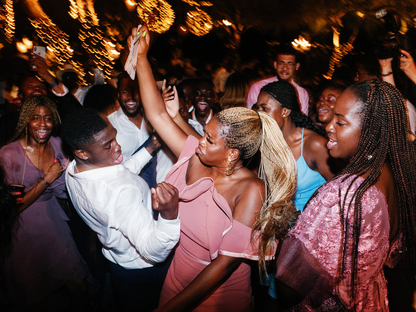 Guests dancing together late at night at Island Resort The Residence Athens Riviera wedding celebration.