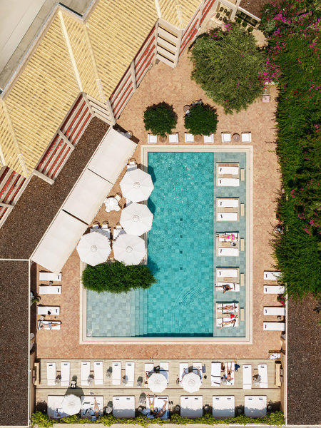 Overhead view of resort pool and sun loungers at Margi Hotel Athens Riviera