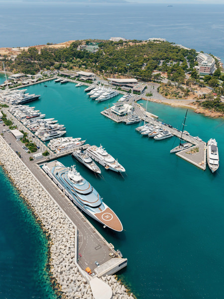 Aerial view of luxury yachts docked in turquoise marina waters near Island Resort Athens