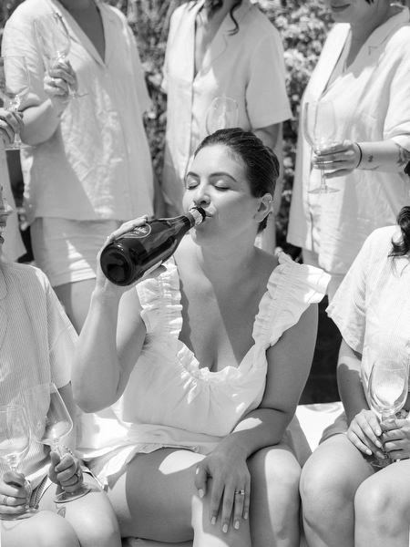 Bride enjoying champagne during relaxed morning preparations at Margi Hotel