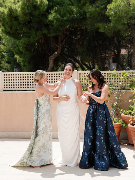 Bridesmaids helping bride with final touches before ceremony on Athenian Riviera at Margi Hotel