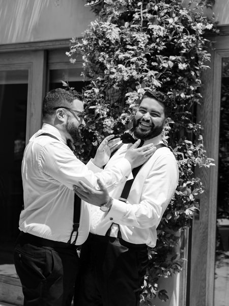 Groom sharing a joyful moment with friend while getting ready before ceremony at Margi luxury hotel