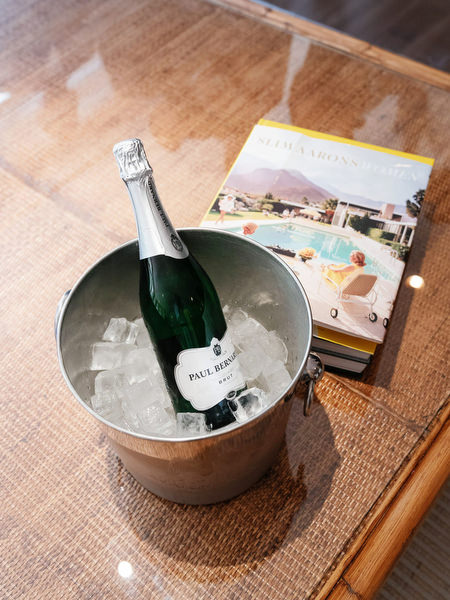 Bottle of champagne chilling in silver bucket during groom preparations at Margi luxury hotel