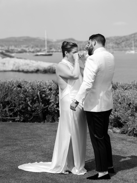 Bride and groom sharing intimate first look moment by the sea before Jewish ceremony
