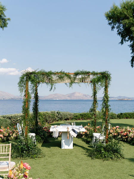 Greenery-covered chuppah overlooking the Mediterranean at Residence venue Island Resort Athens Riviera