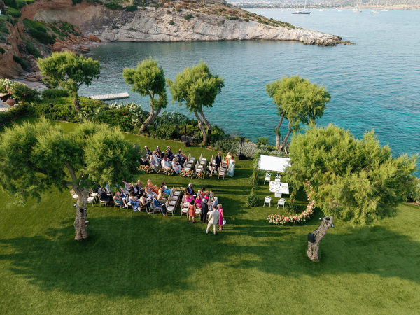Overhead view of guests seated facing the chuppah at the Residence venue Island Resort Athens Riviera