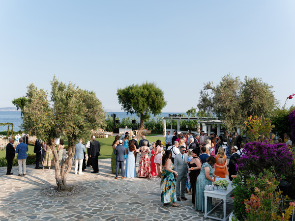 Family and friends mingling in garden courtyard before Jewish ceremony
