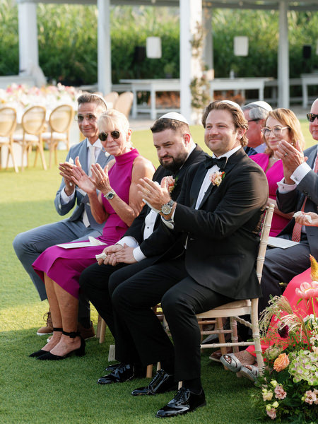 Family and friends applauding during Jewish ceremony