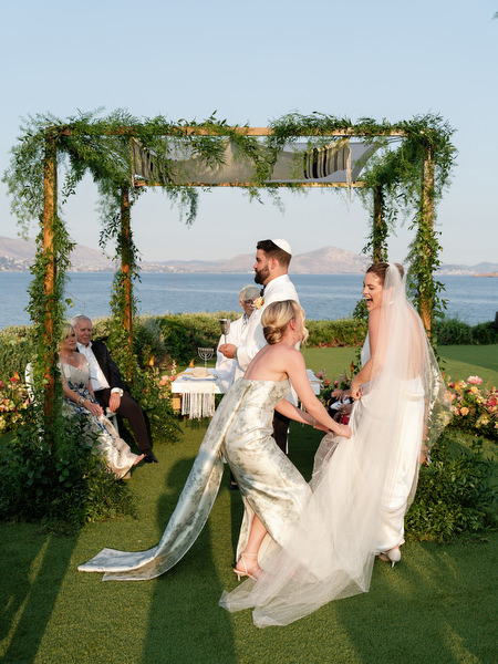 A quiet, intimate moment under the greenery-covered chuppah before the final blessing at Island Residence