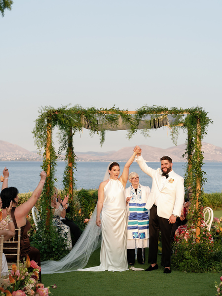 Hands raised in celebration as the ceremony concludes