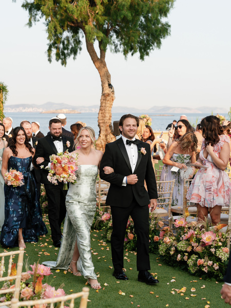 Immediate family raising hands in joy beneath the greenery canopy at Island Residence
