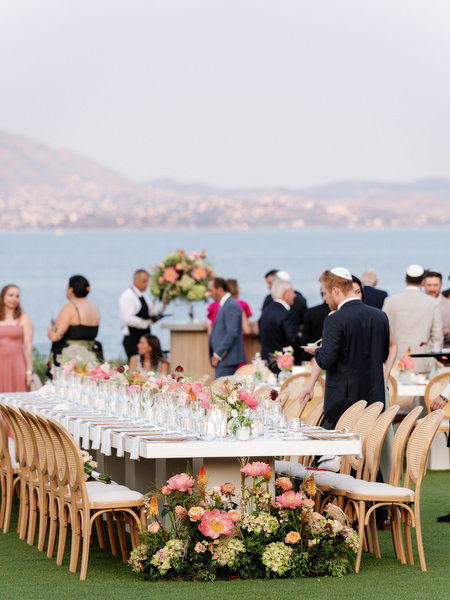Friends gathering near reception tables before dinner begins