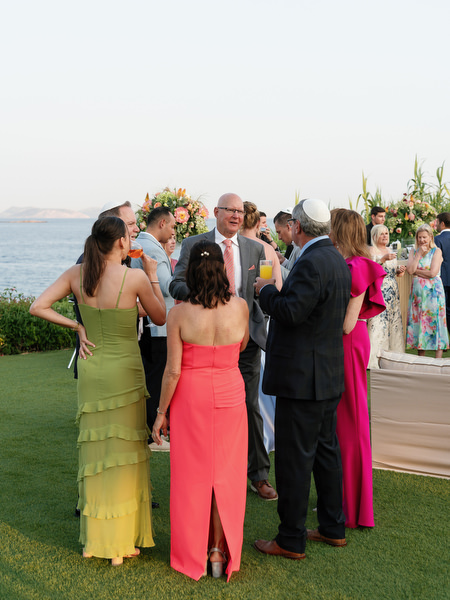 Family and friends socializing in colorful summer formal attire