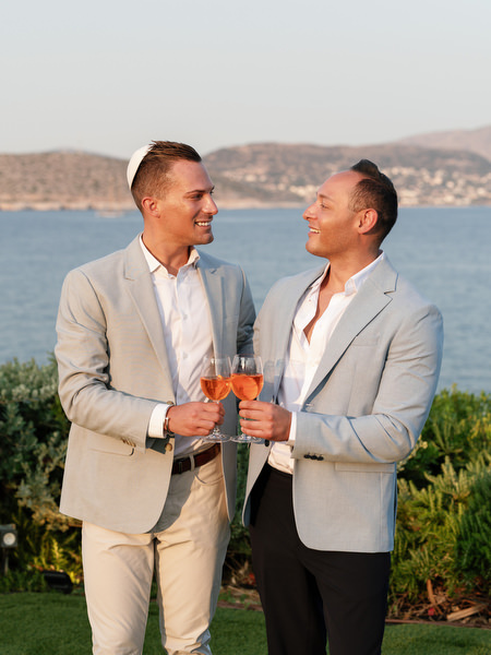 Guests smiling and clinking glasses during golden hour