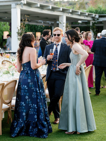 Cocktail hour transitioning toward dinner under the pergola at Island Residence