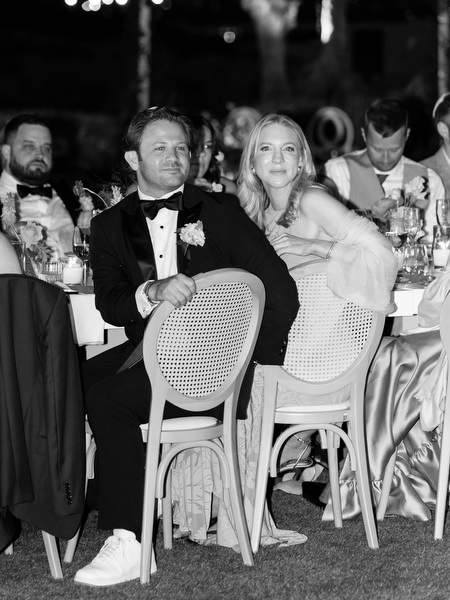 Candid portrait of guests reacting during speeches at Island Residence