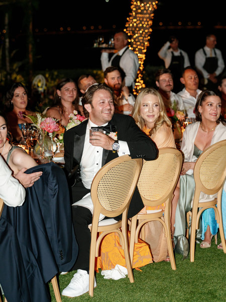 Friends smiling and raising glasses during heartfelt words at Island Residence