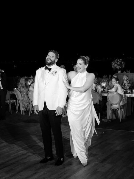 Bride and groom stepping onto the dance floor under night lights at Island Residence