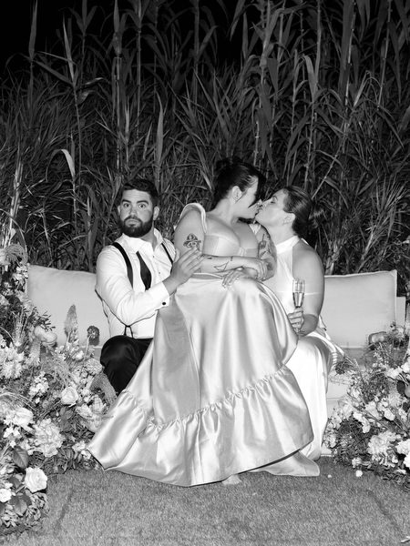 Playful, intimate night portrait surrounded by reception florals at Island Residence