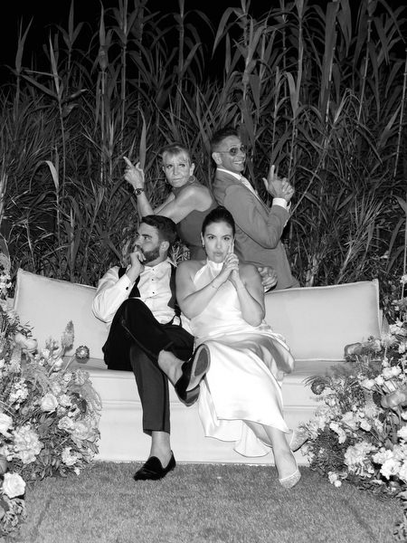 Wedding party striking fun poses for a late-night portrait