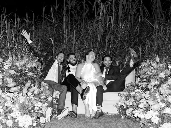 Friends raising arms and legs in celebration