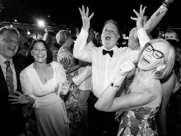 Arms raised, faces lit with laughter mid-song at Island Residence