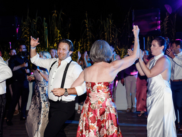 Guests twirling under night lights as the dance floor fills at Island Residence