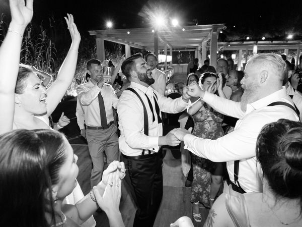 Guests clapping and dancing in tight formation at Island Residence