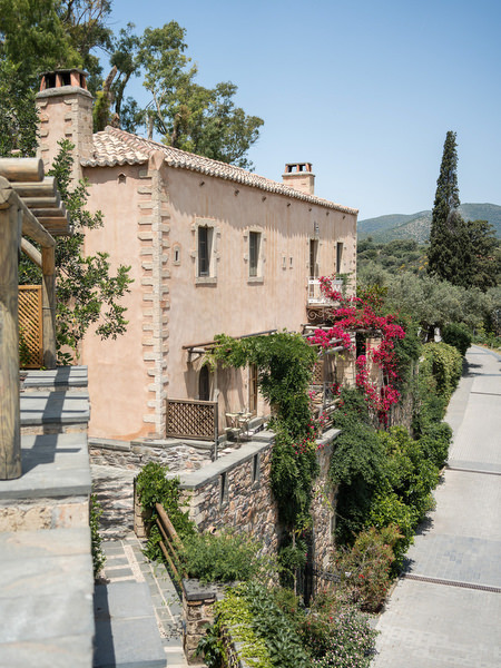 Kinsterna Hotel in Monemvasia Greece with stone architecture and bougainvillea.