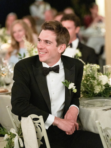 Groom reacting to speech at Kinsterna Hotel wedding Greece.