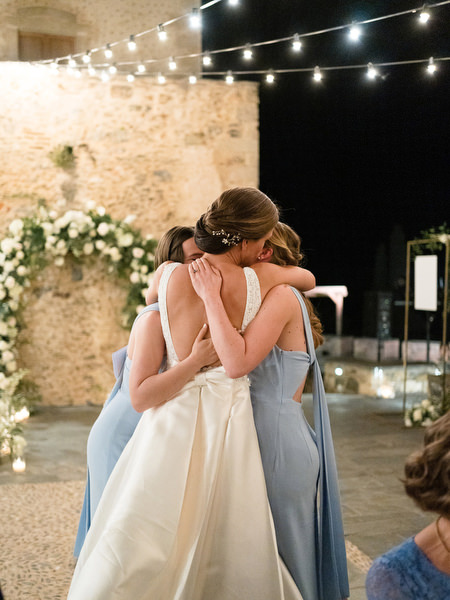 Emotional bridesmaid hug at Kinsterna Hotel wedding.