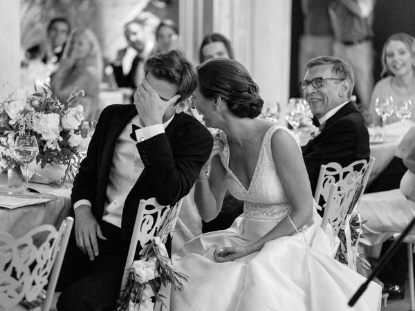 Groom and bride reacting to speech at Kinsterna Hotel wedding Greece.