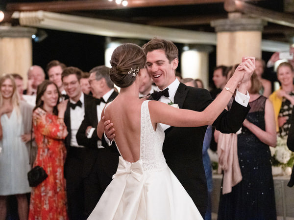 Romantic first dance under string lights at Kinsterna Hotel Greece.