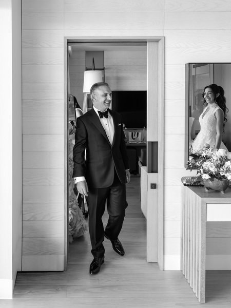 Bride's father arriving in tuxedo during wedding morning preparations in Athens