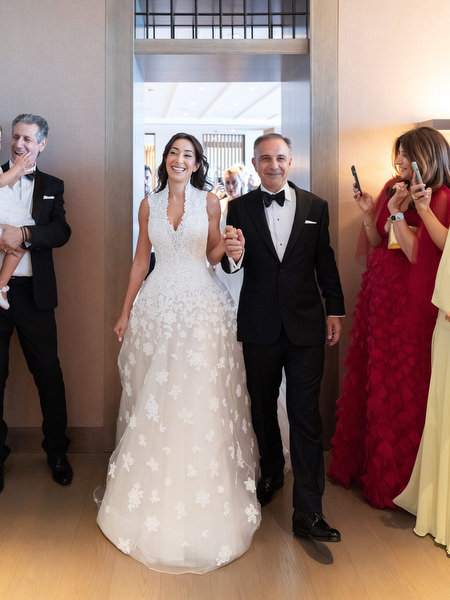 Bride walking with her father before the ceremony at Four Seasons Astir Palace