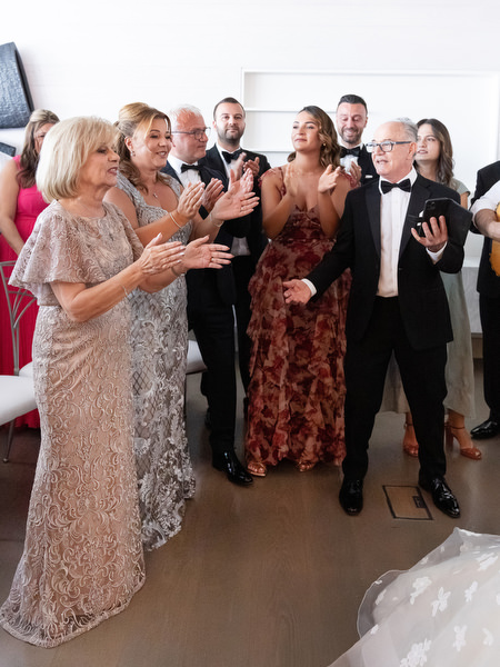 Guests clapping during traditional Cypriot wedding rituals at Four Seasons Astir Palace Athens