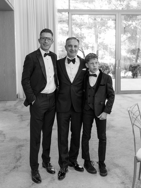 Father and son in formal black-tie attire during luxury Athens wedding preparations