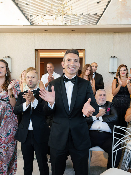 Groom applauding during traditional wedding rituals at a luxury Athens Riviera wedding